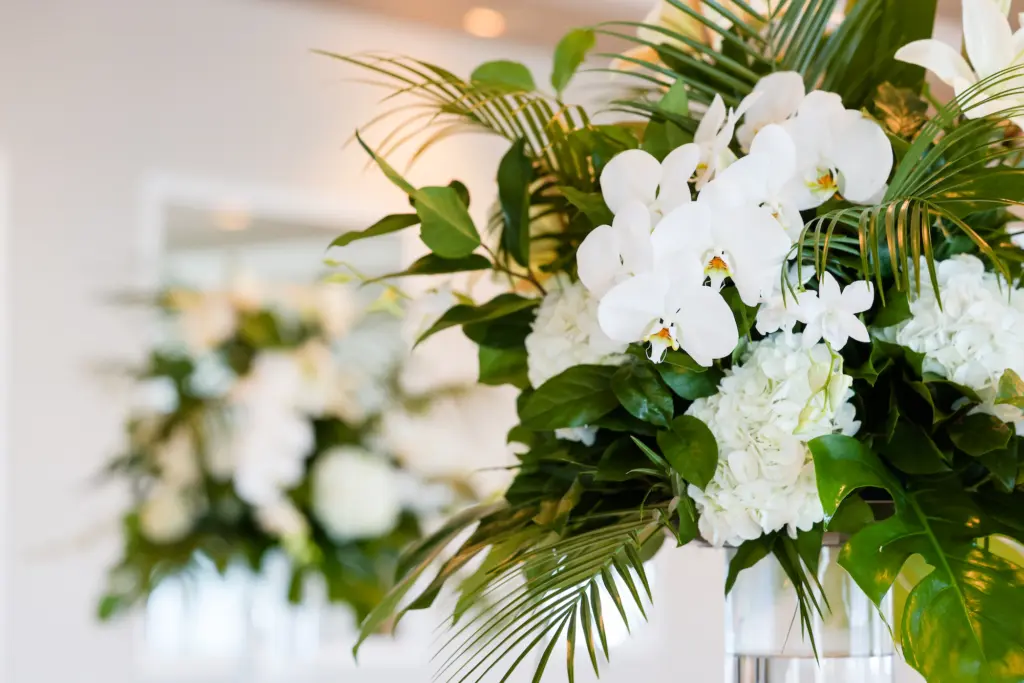 Tropical White Orchids and Hydrangeas with Palm Leaves and Greenery Wedding Ceremony Centerpiece Inspiration
