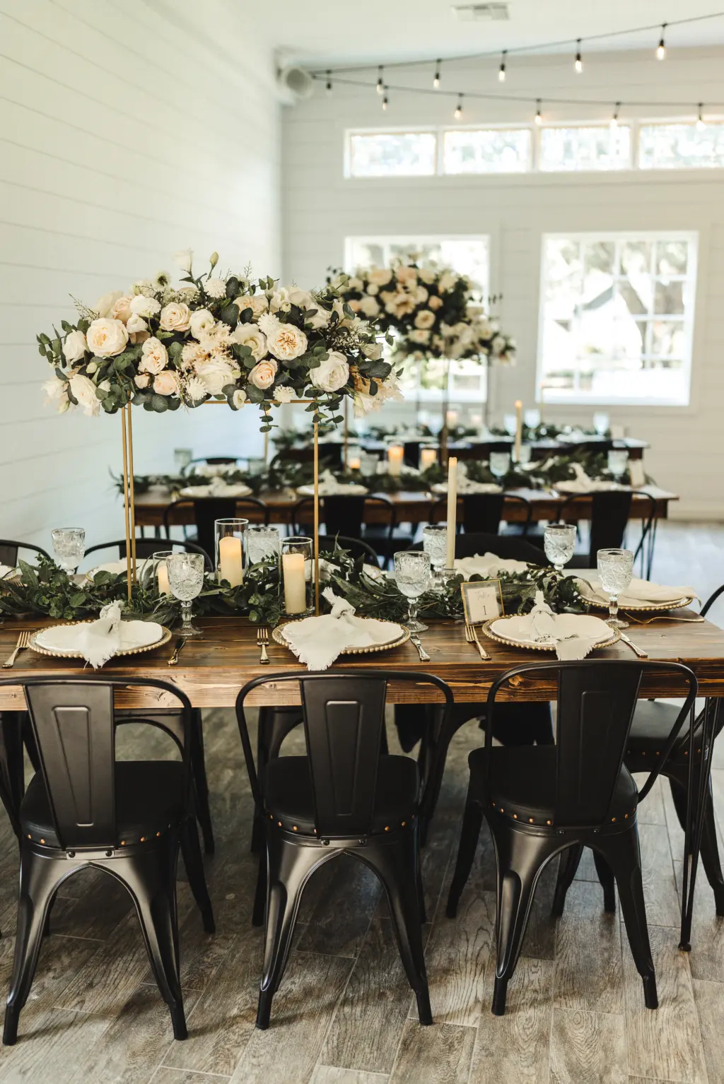 Modern and Rustic Indoor Wedding Reception | Tall Flower Stand Centerpieces with White Roses and Greenery | Tampa Bay Florist Monarch Events and Design