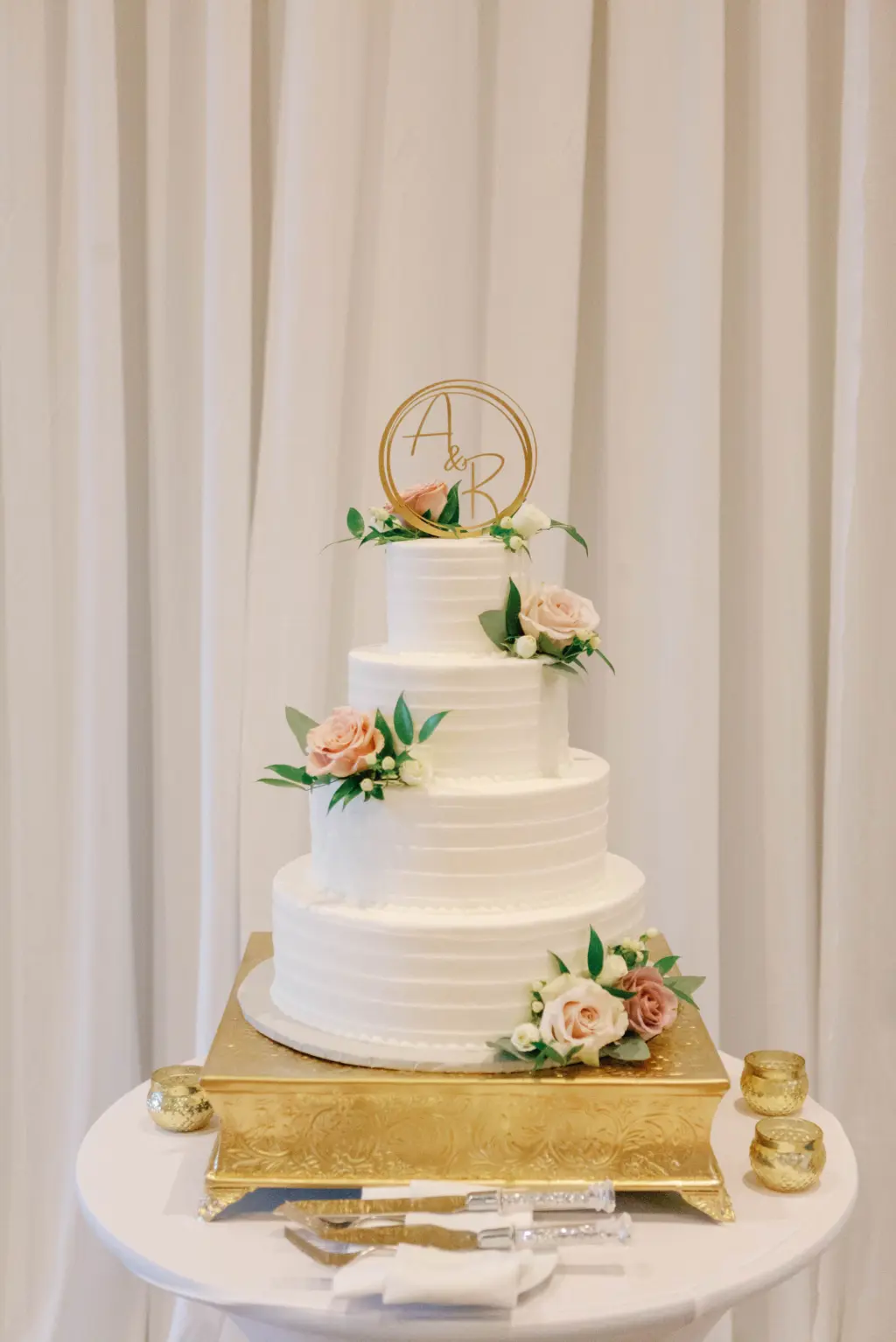 Classic Four Tier Round White Wedding Cake with Blush Floral Details and Gold Cake Topper