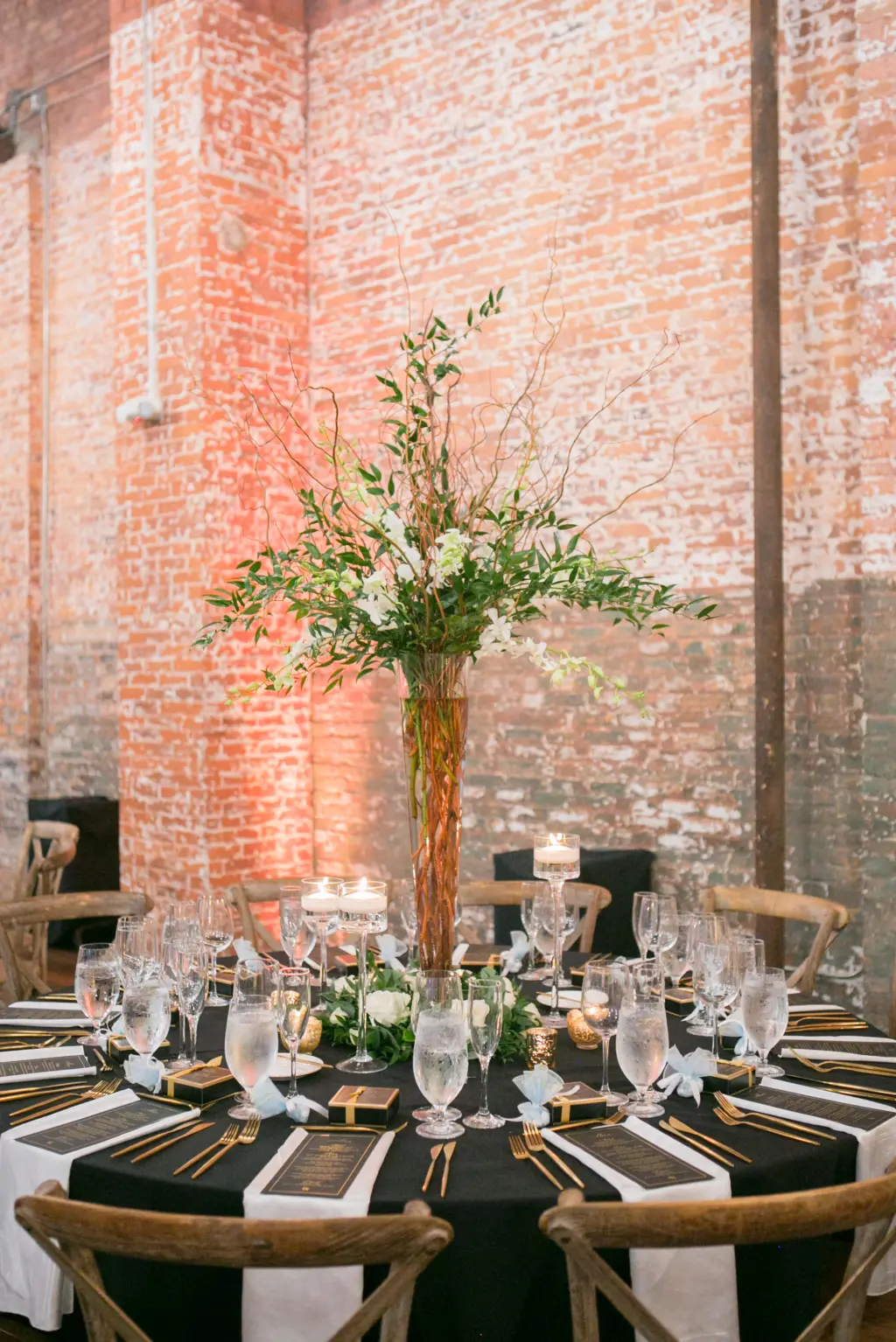 Tall Vase Centerpiece Inspiration with Branches, Greenery, and Stock Flowers | Modern Black and Gold Wedding Reception Table Setting Ideas | Tampa Bay Kate Ryan Event Rentals