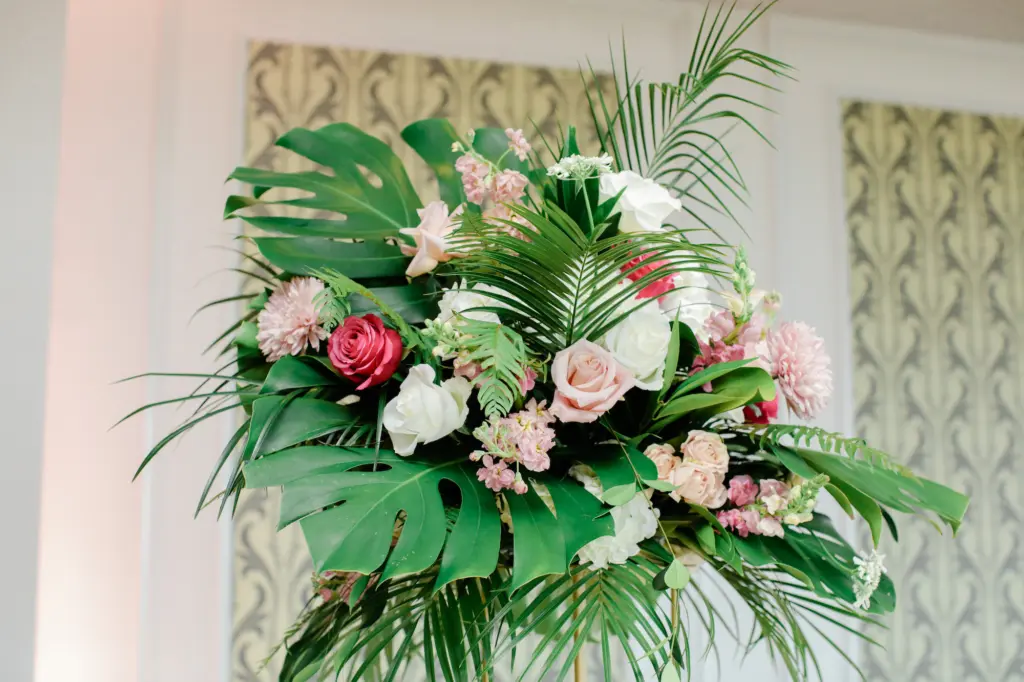 Tropical Centerpieces with Palm Leaves, Monstera, and Pink and Red Roses Inspiration