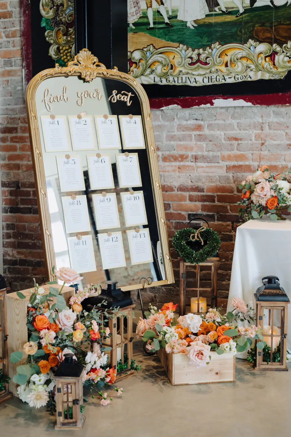 Find Your Seat Gold Mirror Seating Chart for Wedding Reception Inspiration | Lanterns with Orange, White, and Pink Roses with Greenery