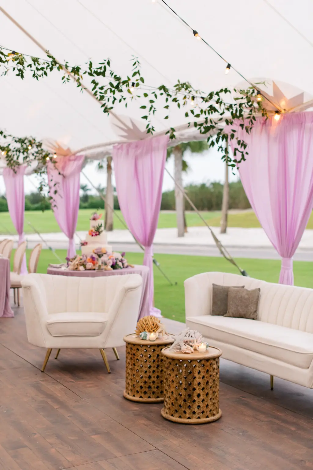 Cream Lounge Furniture for Wedding Reception | Hanging Ruscus Greenery and Purple Drapery