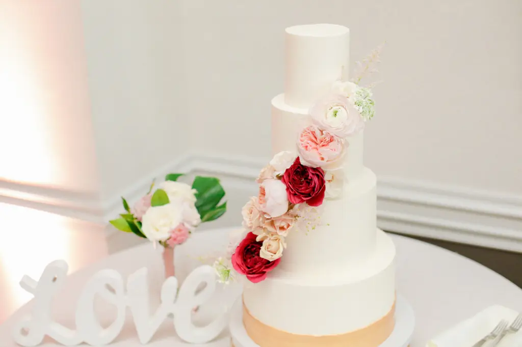 Four Tier White Wedding Cake with Gold Detail and Red and Pink Floral Design | Tampa Bay Cake Company