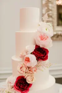 Four Tier White Wedding Cake with Gold Detail and Red and Pink Floral Design | Tampa Bay Cake Company