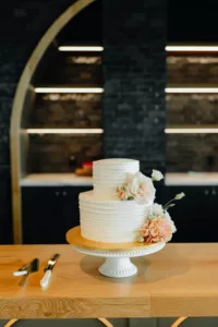Modern Round Two-Tier Buttercream Wedding Cake with White Roses and Pink Carnation Inspiration