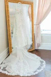 Essence of Australia Wedding Dress Hanging from Mirror in Bridal Suite Wedding Portrait