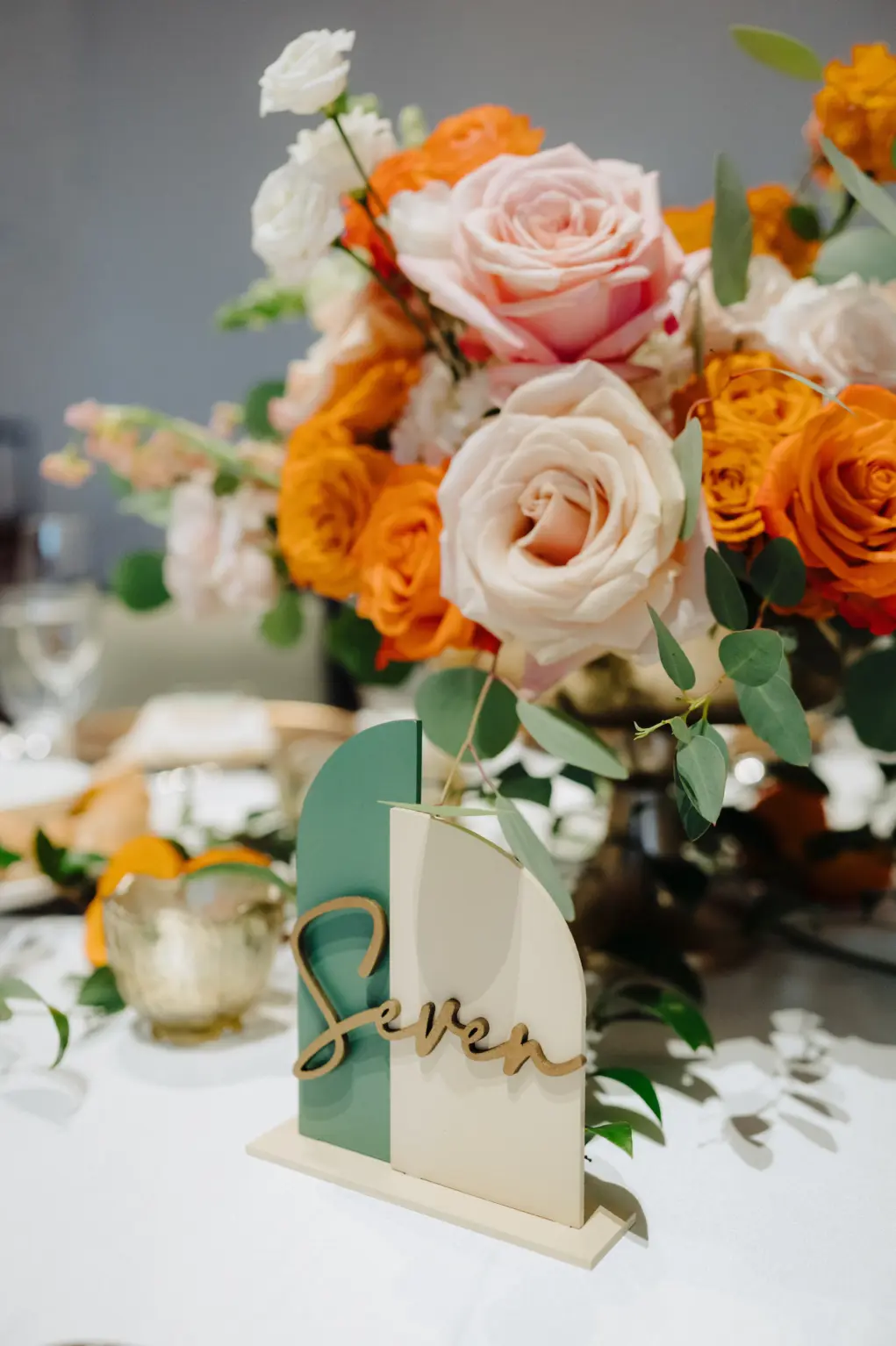 Modern Green and Cream Half Arch Wedding Reception Table Number Ideas | Pink and Orange Rose Centerpiece Inspiration