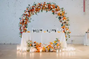 Round Circular Arch Backdrop for Wedding Reception with Pink, Orange, and White Flowers with Greenery and Candles | Tampa Bay Planner Lemon Drops Weddings and Events | Venue Hotel Haya