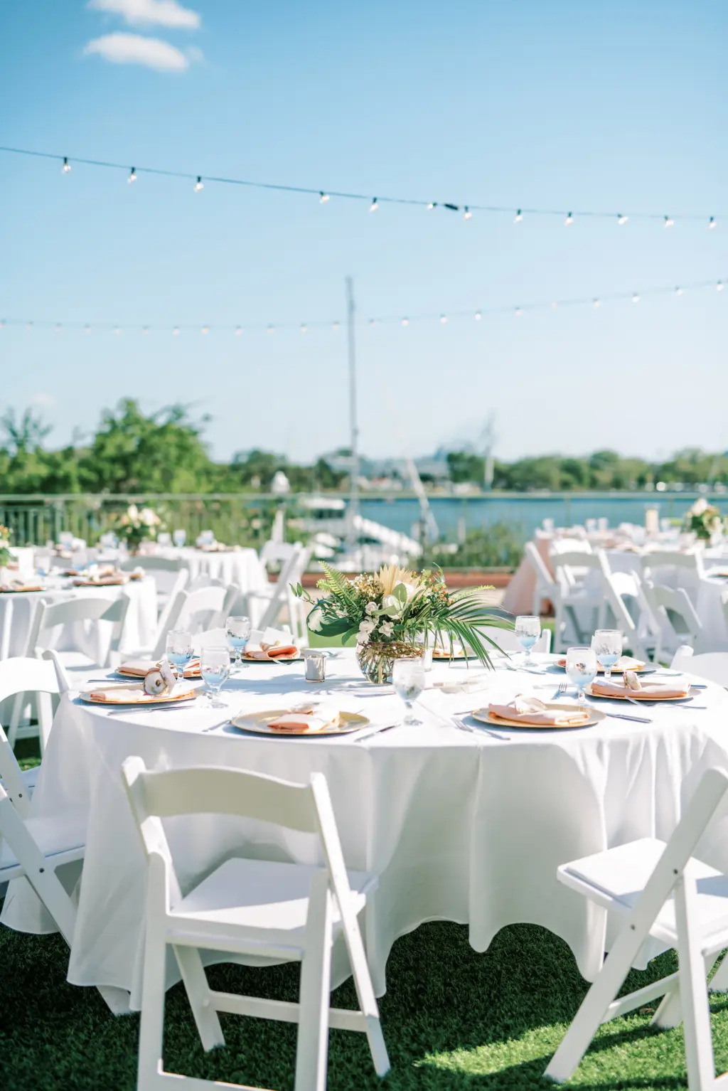White Garden Chairs and Linen with Blush Napkins | Palm Frond Centerpiece Ideas | Outdoor Old Florida Wedding Reception Inspiration | St. Pete Rentals Gabro Event Services