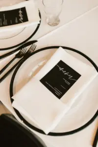 Modern Black Menu Card with Black-rimmed Charger and Black Flatware from Tampa Bay Event Rentals A Chair Affair | Spring Black and White Wedding Reception Ideas