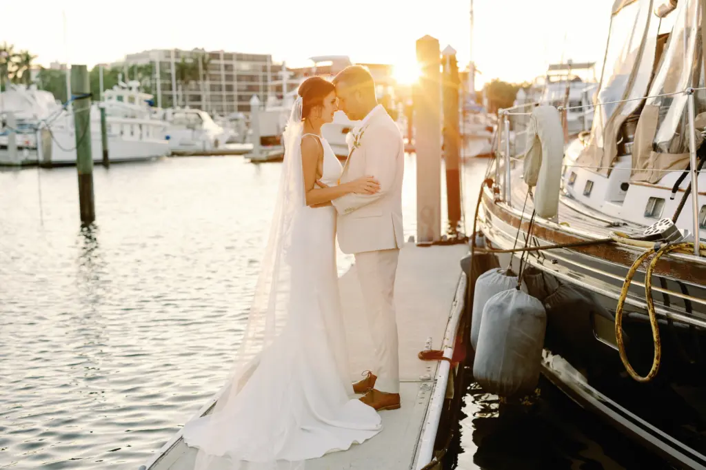 Bride and Groom Golden Hour Waterfront Intimate Forehead Touch Wedding Portrait | Sarasota Planner Breezin Weddings | Waterfront Venue Pier 22