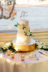 Classic Round Three Tier White Wedding Cake with White Floral and Greenery Detailing and Gold Laser Cut Wedding Cake Topper Inspiration