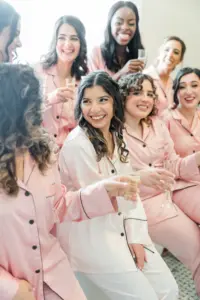 Bride and Bridesmaids in Blush Silk Pajamas Getting Ready Wedding Portrait