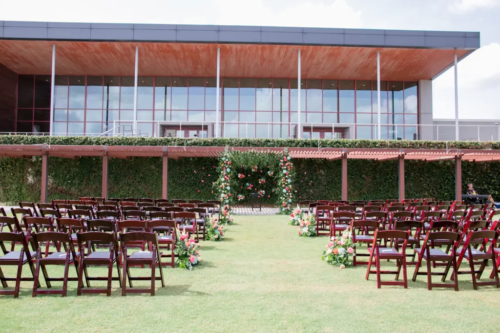 Outdoor Gold Course Wedding Ceremony with Brown Folding Chairs and Floral Arch | Bowling Green Streamsong Resort | Florist Monarch Events and Designs