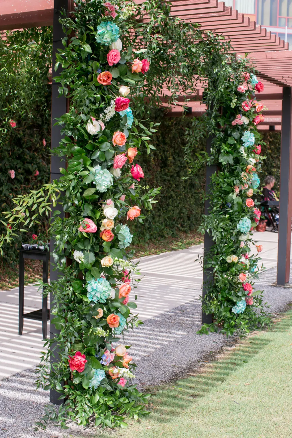 Unique Floral and Greenery Wedding Arch Inspiration with Orange, Turquoise, and Pink Floral Details | Central Florida Wedding Florist Monarch Events and Designs