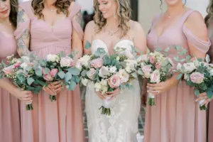 Pink and White Roses, Greenery, and Baby's Breath Wedding Bouquet Ideas | Azazie Dusty Rose Bridesmaids and Bride Oleg Cassini Wedding Dress