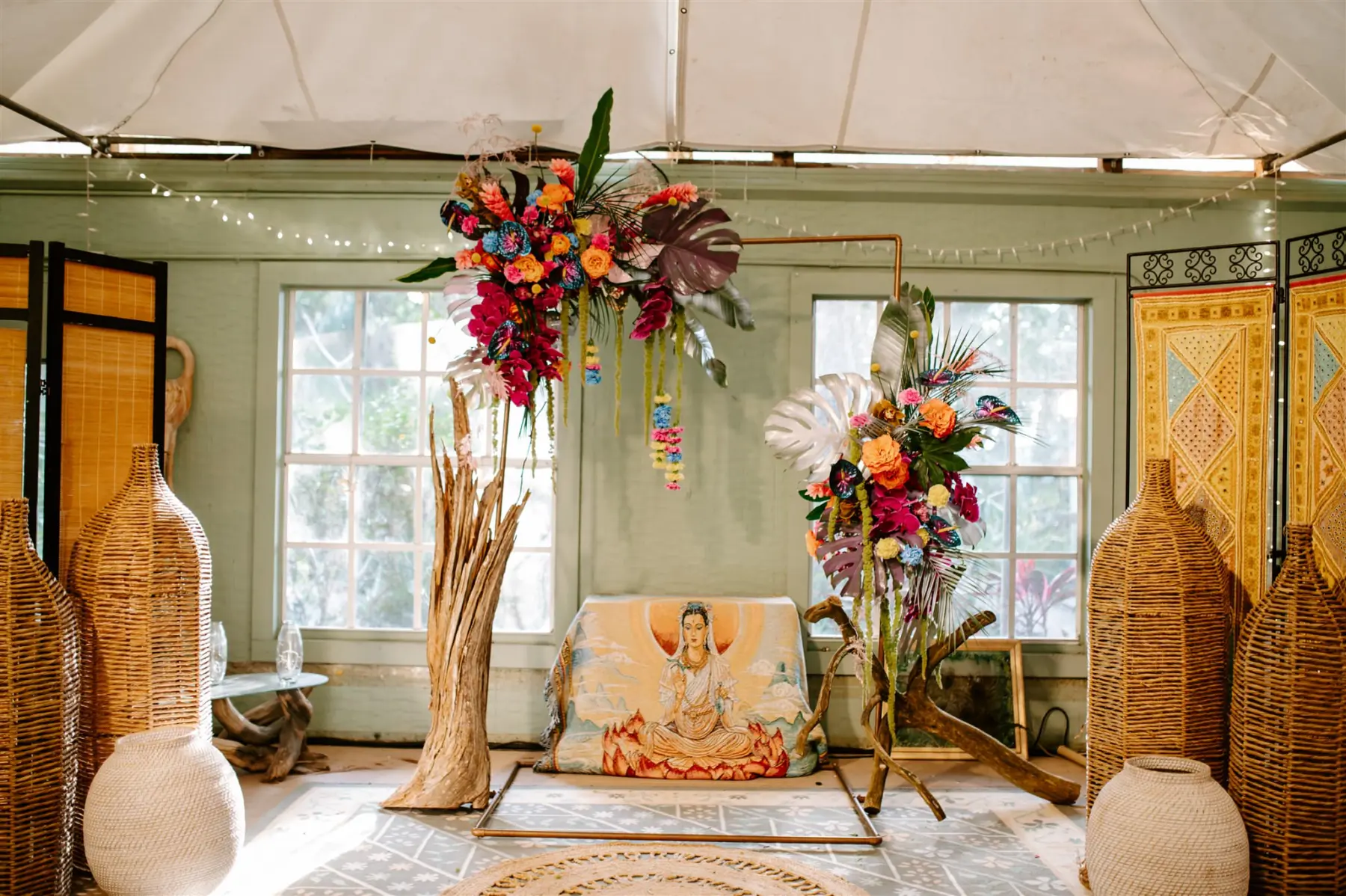 Colorful Boho Tropical Indoor Wedding Ceremony Arbor Arrangement Ideas | Monstera Leaf, Palm Leaf, Pink Orchids, Orange Roses, Yellow Pom Flower, and Red Ginger Floral Decor Inspiration