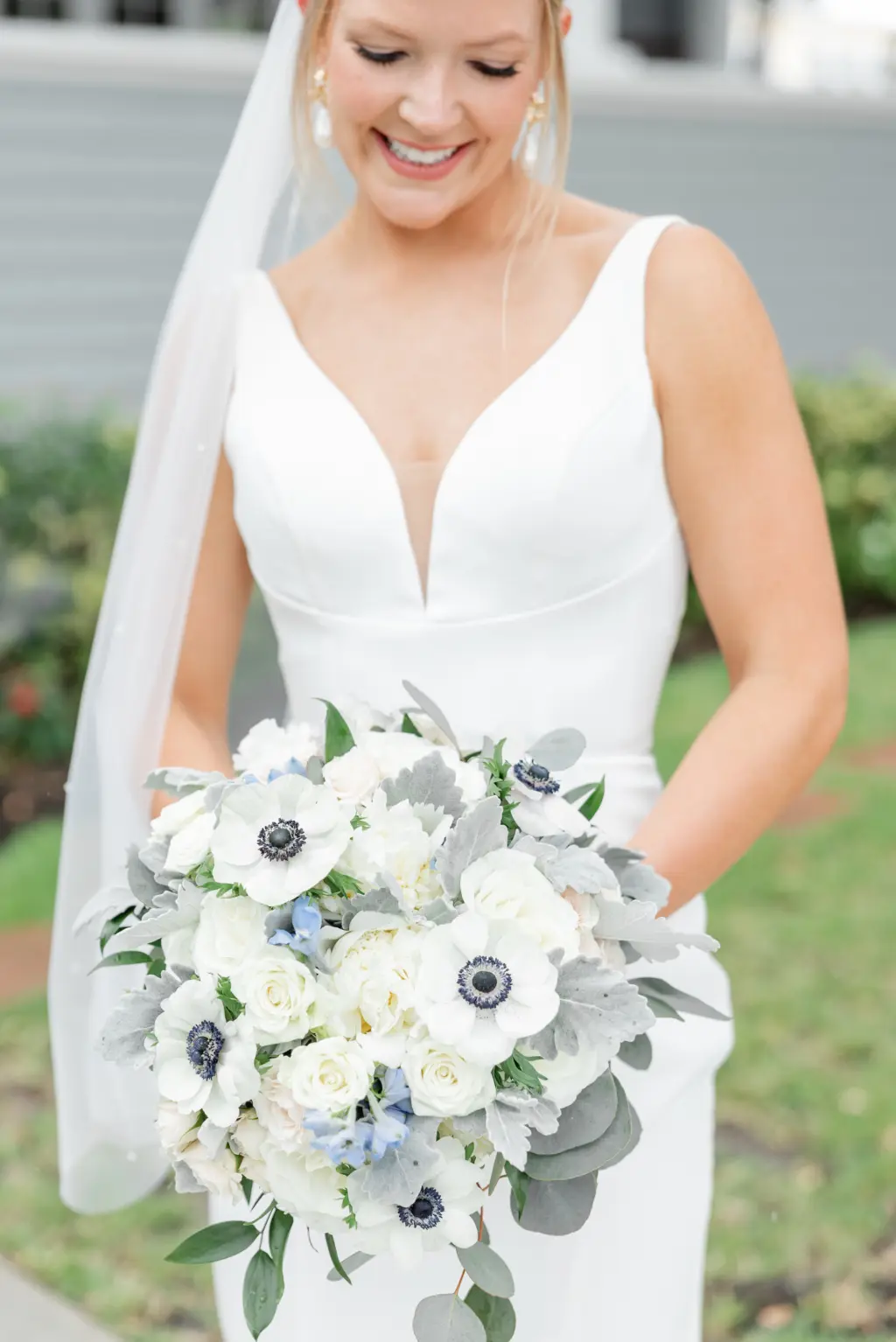White Anemone, Roses, Blue Flowers, and Greenery Wedding Bouquet | Bridal Updo Ideas | Tampa Bay Florist Monarch Events and Design | Dress Boutique Truly Forever Bridal