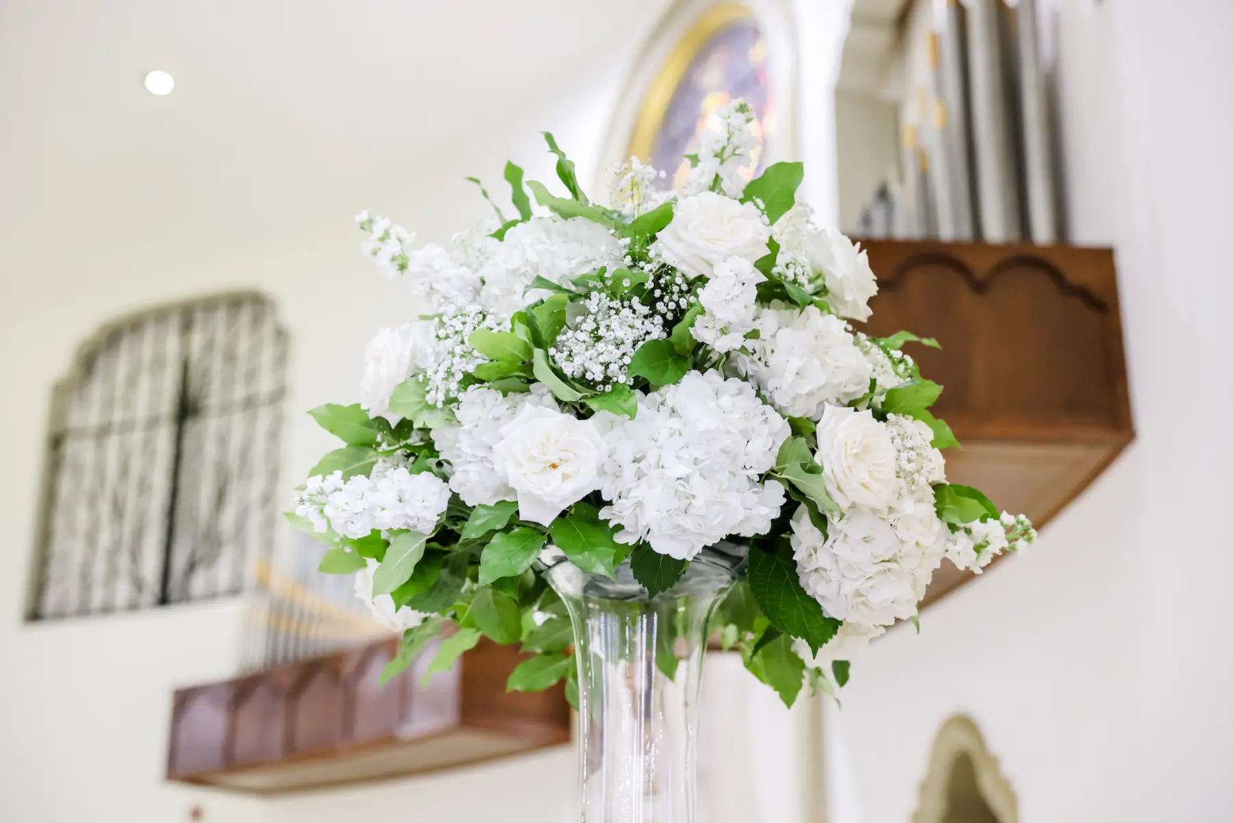 Elegant White Hydrangea, Rose, Baby's Breath, and Greenery Wedding Ceremony Flower Arrangement Decor Inspiration