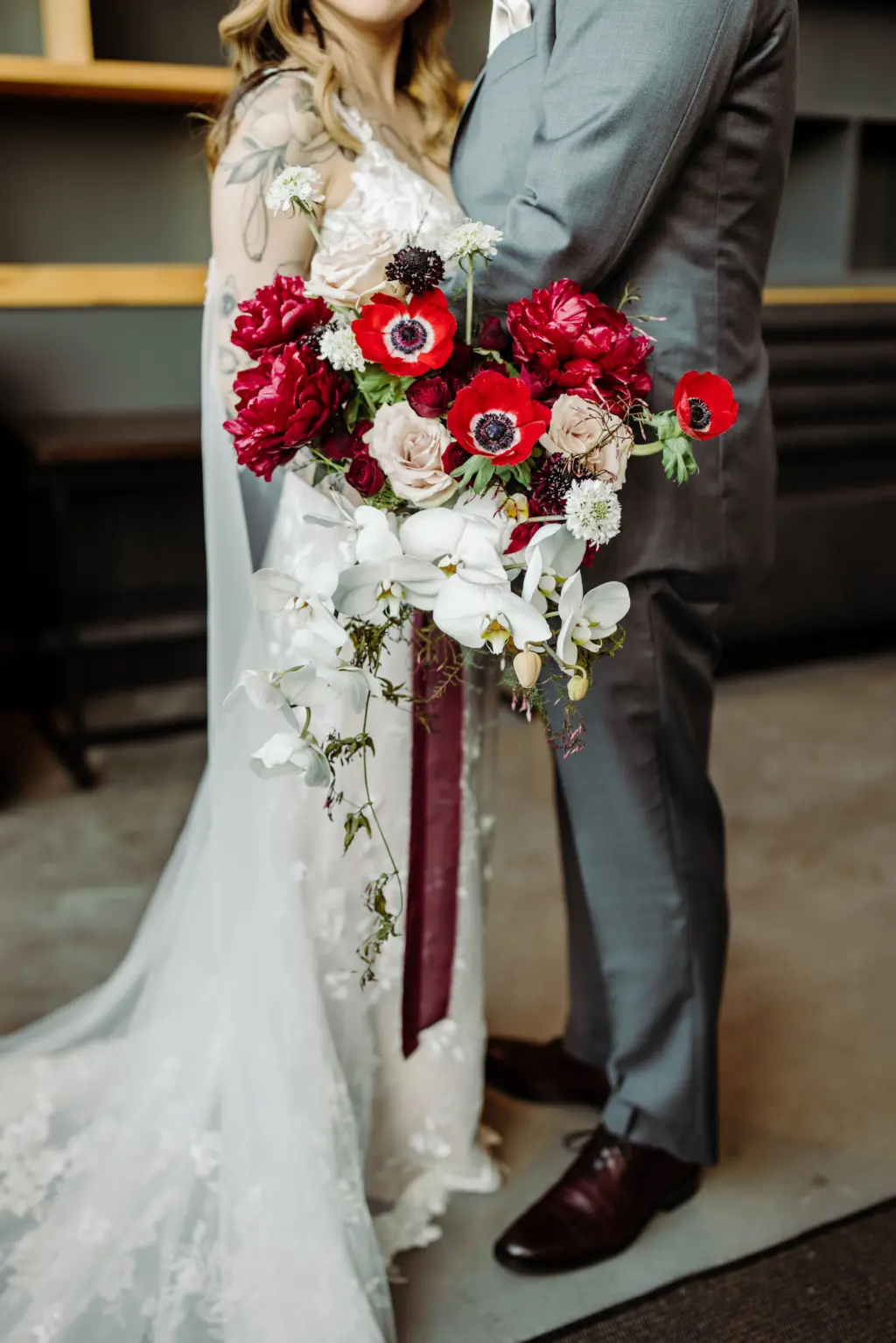 Red Anemone, Carnations, and Cascading White Orchids Wedding Bouquet Inspiration