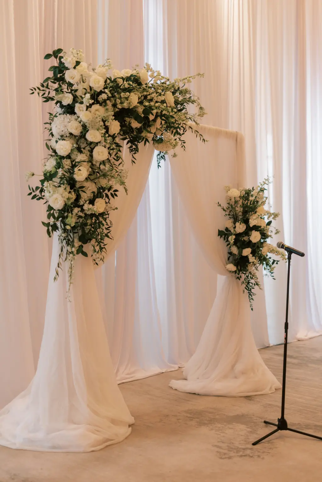 White Pipe and Drapery for Wedding Ceremony | Monochromatic Floral Arrangement for Wedding Ceremony Arch | Garden Roses, Stock Flowers, and Greenery | Tampa Bay Rental Company Gabro Event Services