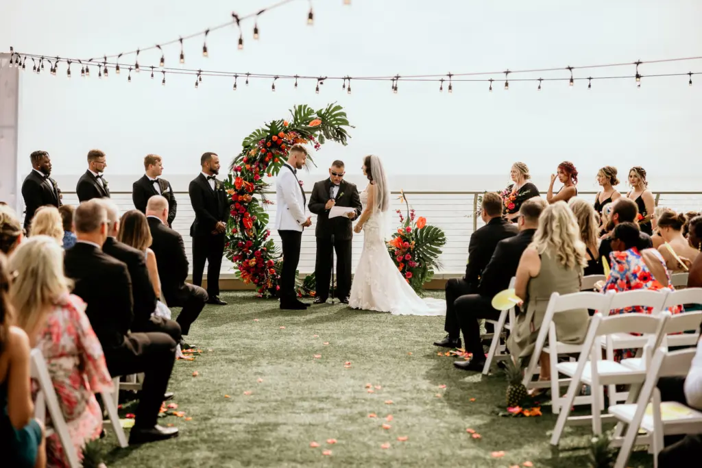 Tropical Semi Circle Arch with Monstera Leaves and Bright Tropical Florals | Wedding Ceremony Decor Inspiration | Clearwater Florist Save the Date Florida | Planner Elegant Affairs by Design | Venue Opal Sands