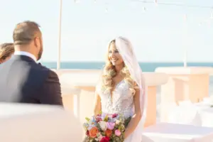 Bride and Groom Exchanging Vows in Intimate Rooftop Beach Wedding Inspiration