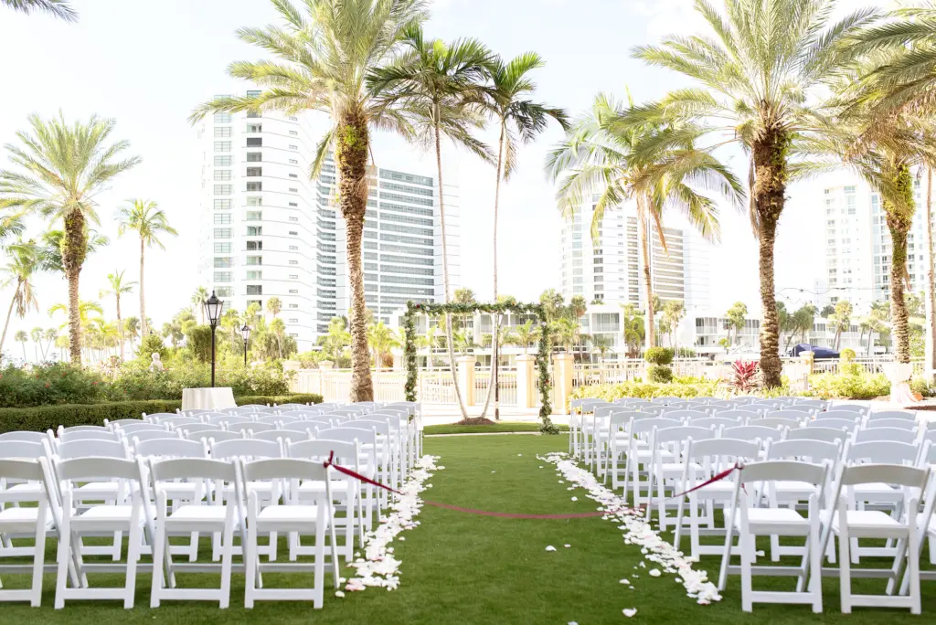 Classic Outdoor Waterfront Burgundy Wedding Ceremony Ideas | White Garden Folding Garden Chairs | Ritz Carlton Sarasota