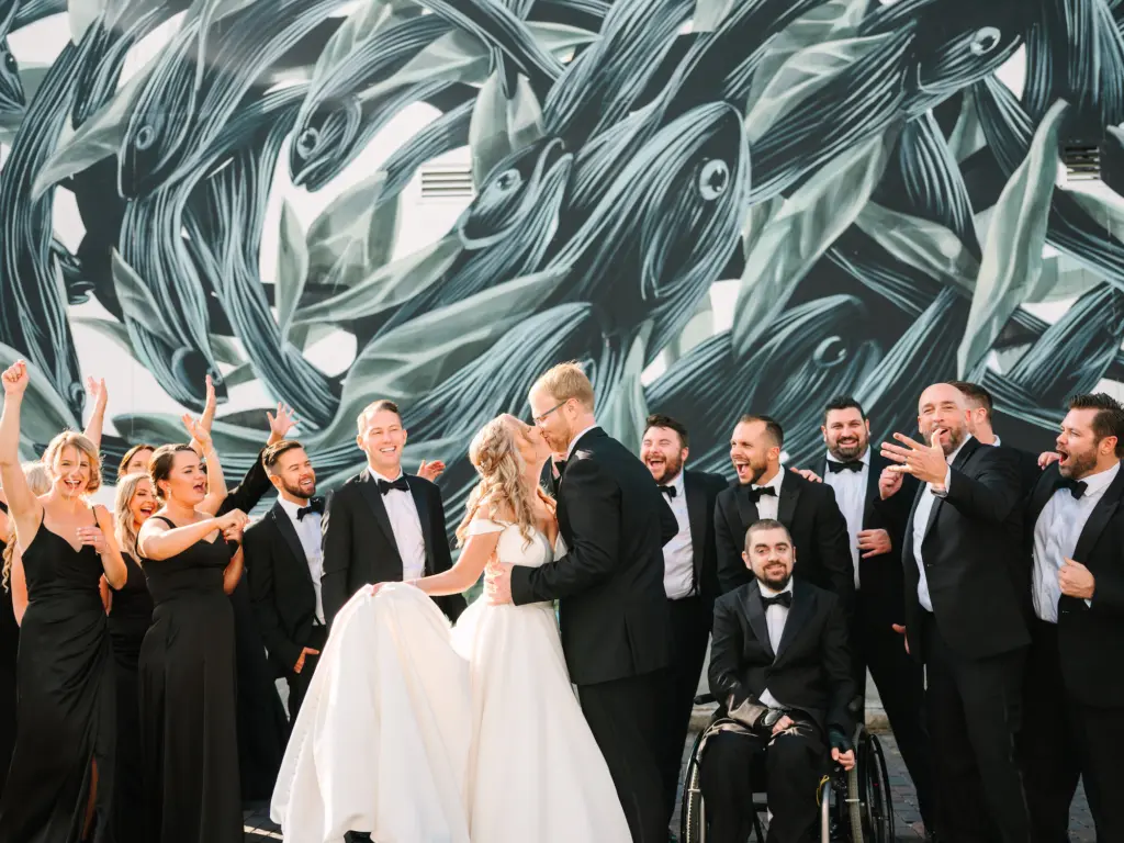 Mismatched Black Bridesmaid Dresses and Tuxedos Wedding Party Attire Ideas | Downtown St. Petersburg Florida Wall Mural Wedding Party Photo Op Backdrop Inspiration