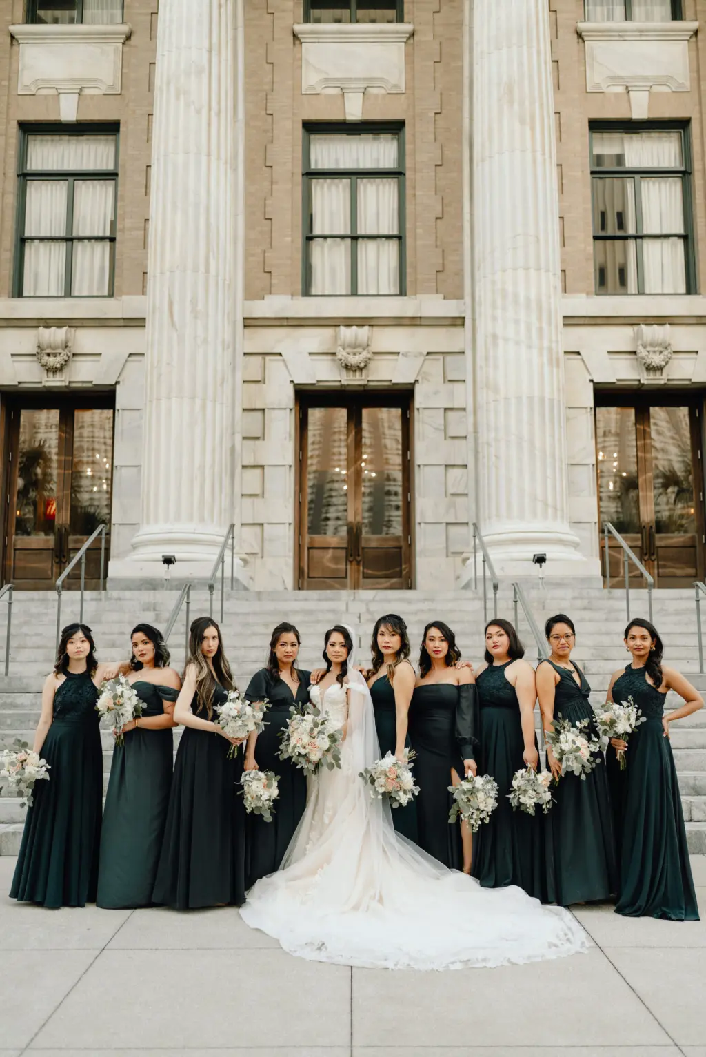 Bride and Bridesmaids Wedding Portrait | Bridesmaids in Floor Length Mix and Match Bridesmaids Dresses Holding White Floral Bouquets with Eucalyptus | Downtown Tampa Wedding Venue Le Meridien | Tampa Hair and Makeup Femme Akoi | Videographer Shannon Kelly Films | Photographer J&S Media
