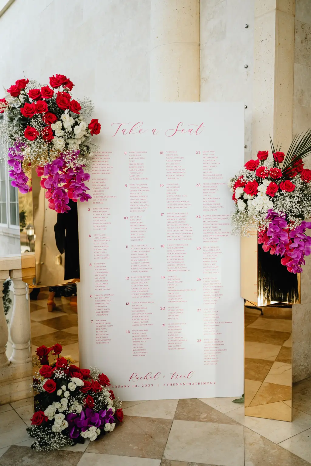 Asian Fusion Wedding Reception White Acrylic Seating Chart with Purple Cursive Writing and Rend and Fuchsia Floral Décor Inspiration