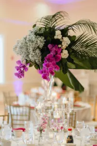 Tropical Leave Wedding Centerpiece with Purple Orchids and White Floral Detailing in Asian Fusion Wedding Reception Décor