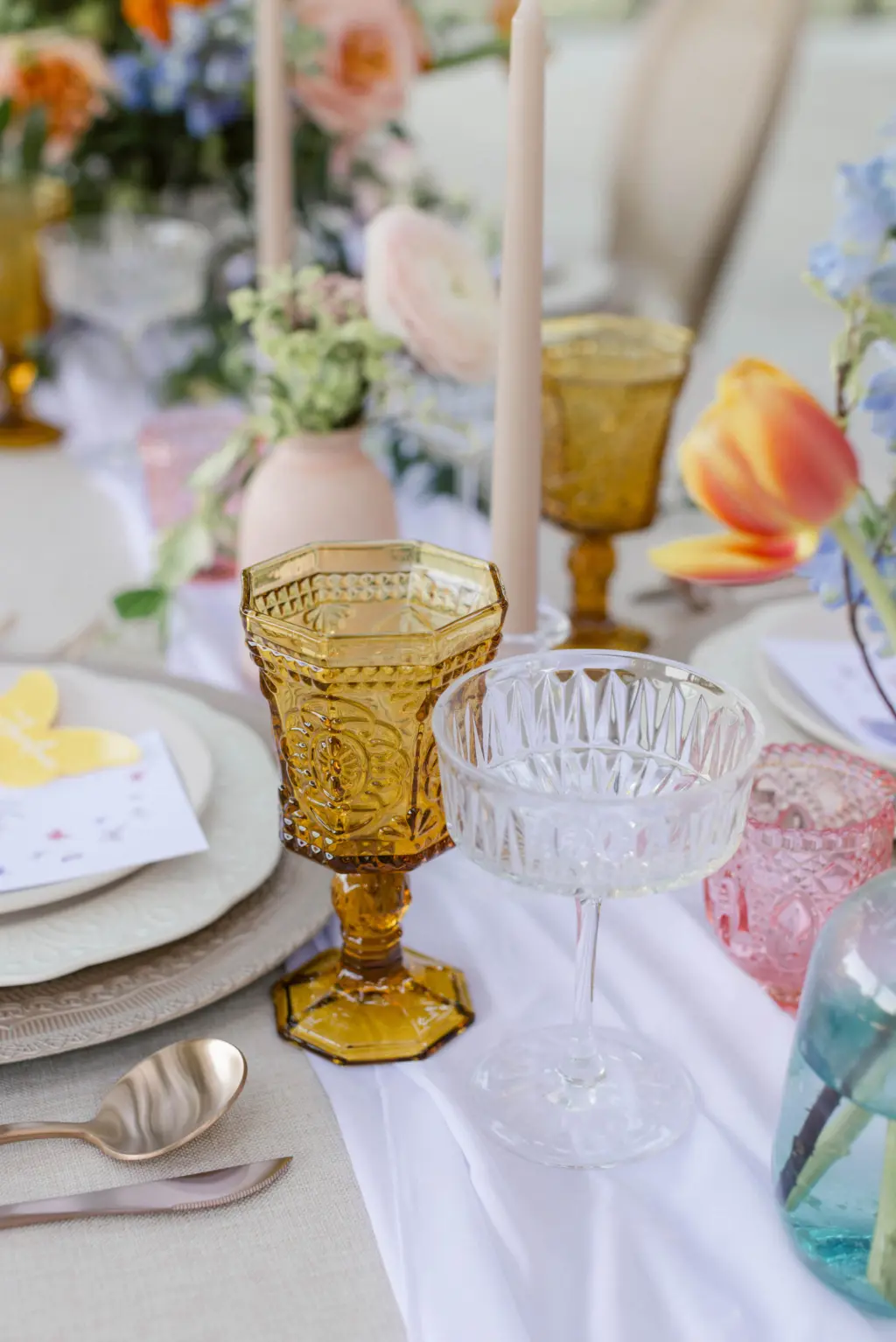 Whimsical Spring Vineyard Inspired Wedding Reception Decor Ideas with Colored Vintage Goblets and Coupe Glasses