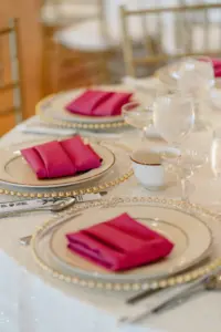 Fuchsia Pink Napkins on Clear Beaded Chargers and White Platting with Silver Flatware Tablescape Place Setting Inspiration