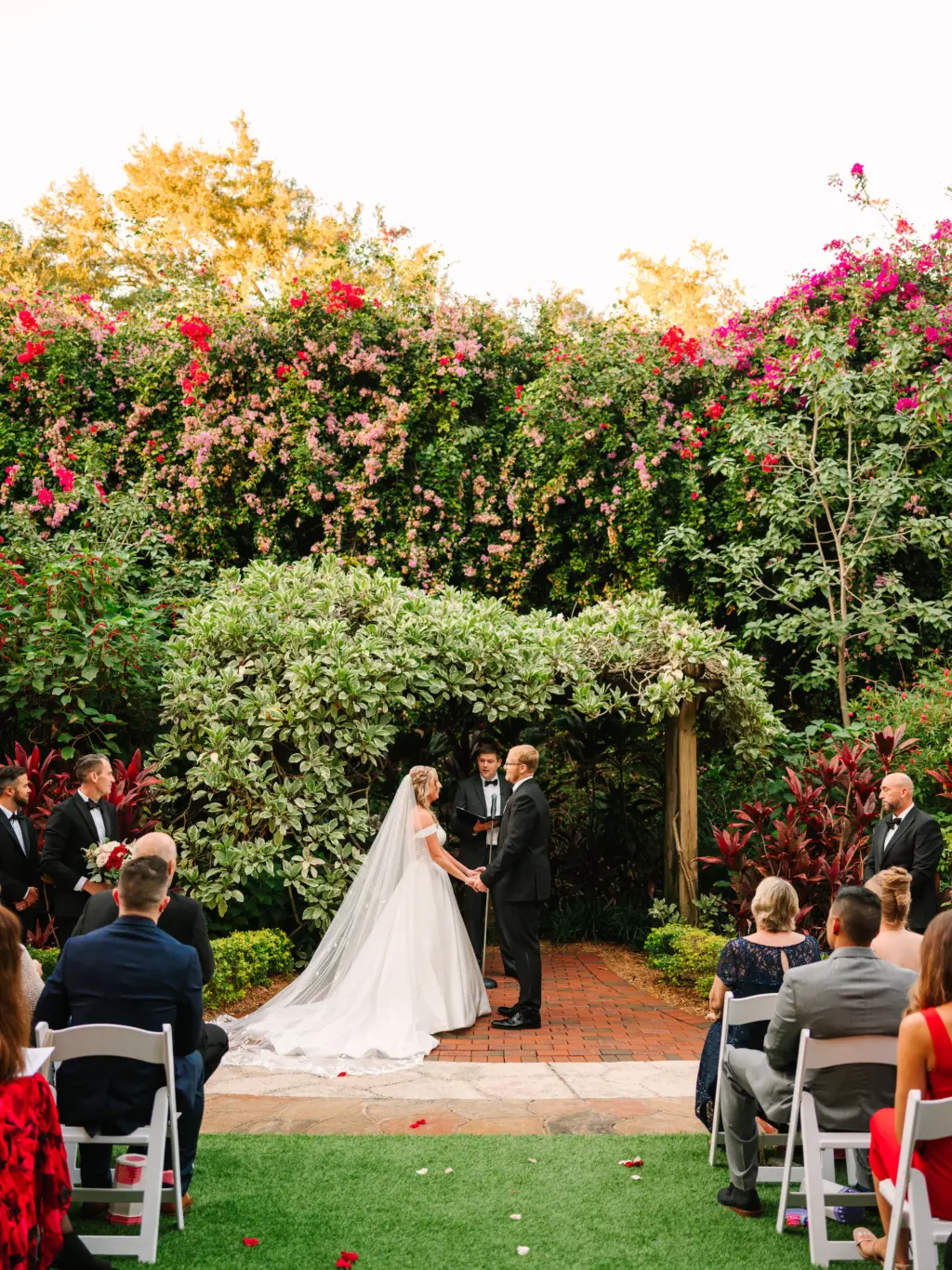 Bride and Groom Exchanging Vows in a Christmas Inspired Garden Wedding Ceremony | Downtown St. Petersburg Florida Event Venue Sunken Gardens
