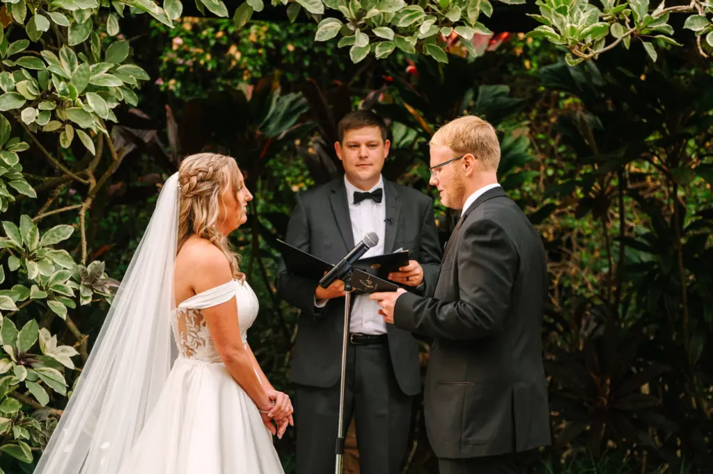 Bride and Groom Exchanging Vows in a Christmas Inspired Garden Wedding Ceremony