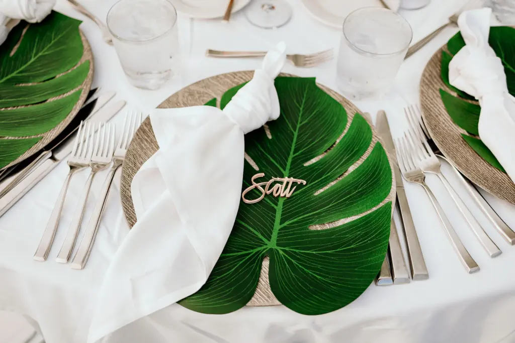 Beige and Cream Place Setting with Monstera Leaf and Laser Cut Name Detailing Wedding Reception Tropical Decor Inspiration | Tampa Florist Save the Date Florida | Planner Elegant Affairs by Design