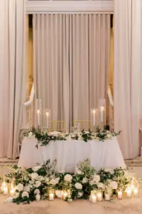 Romantic Candlelit Sweetheart Table Wedding Reception Decor Inspiration | Floor Flower Arrangements with White Roses and Greenery
