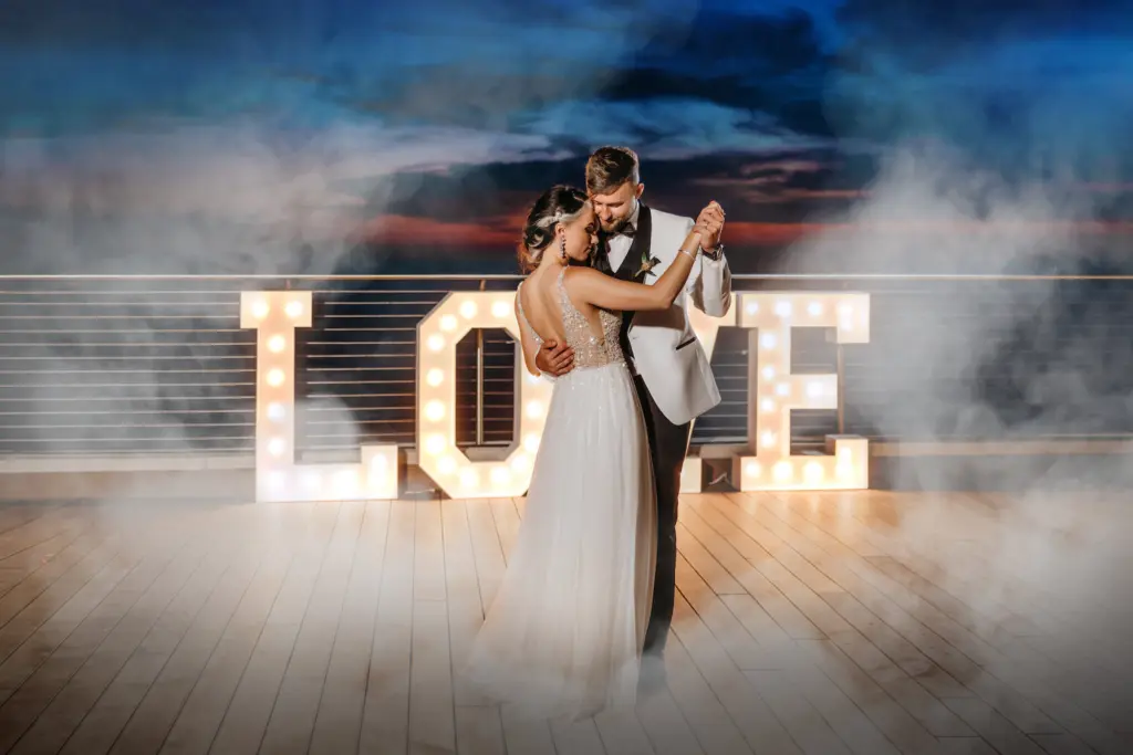 Bride and Groom First Dance with Marquee Letters Spelling LOVE | Tampa Wedding DJ Grant Hemond Associates | Planner Elegant Affairs by Design
