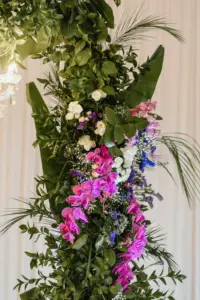 Tropical Leaves Wedding Reception Tablescape Décor with Purple Orchids and White and Purple Floral Detailing in Asian Fusion Wedding Décor Inspiration