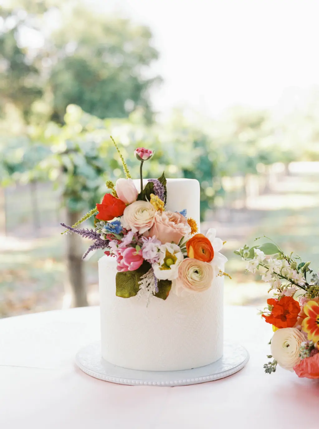 Round Two-Tiered White Textured Wedding Cake with Colorful Flower Accents | Wedding Reception Dessert Table Ideas | Tampa Bay Florist Save The Date Florida