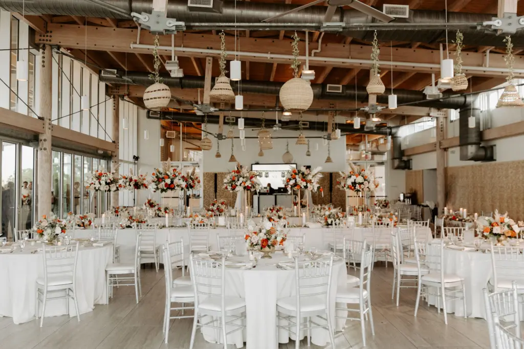 Boho Wedding Reception Inspiration | Silver Chiavari Chairs with White Linen | Orange, Pink, and White Roses with Greenery Centerpiece Ideas | Tampa Bay Planner Breezin Weddings | Venue Tampa River Center