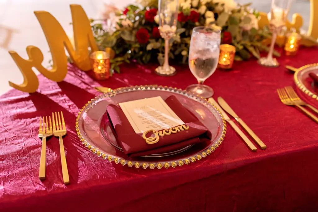 Classic Fall Burgundy Wedding Reception Table Setting with Gold Flatware Ideas | Laser-Cut Groom Place Card Inspiration