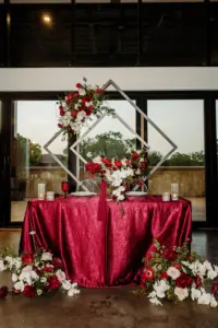 Sweetheart Table with Geometric Backdrop Red Crepe Tablecloth Cascading White Orchids, Red Anemones, Carnations, and Roses | Chinese Infused Wedding Reception Inspiration | Tampa Bay Kate Ryan Event Rentals