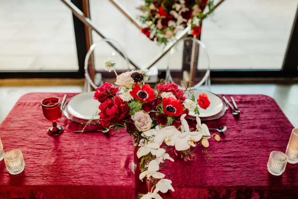 Sweetheart Table with Red Crepe Tablecloth Cascading White Orchids, Red Anemones, Carnations, and Roses | Chinese Infused Wedding Reception Inspiration | Tampa Bay Kate Ryan Event Rentals