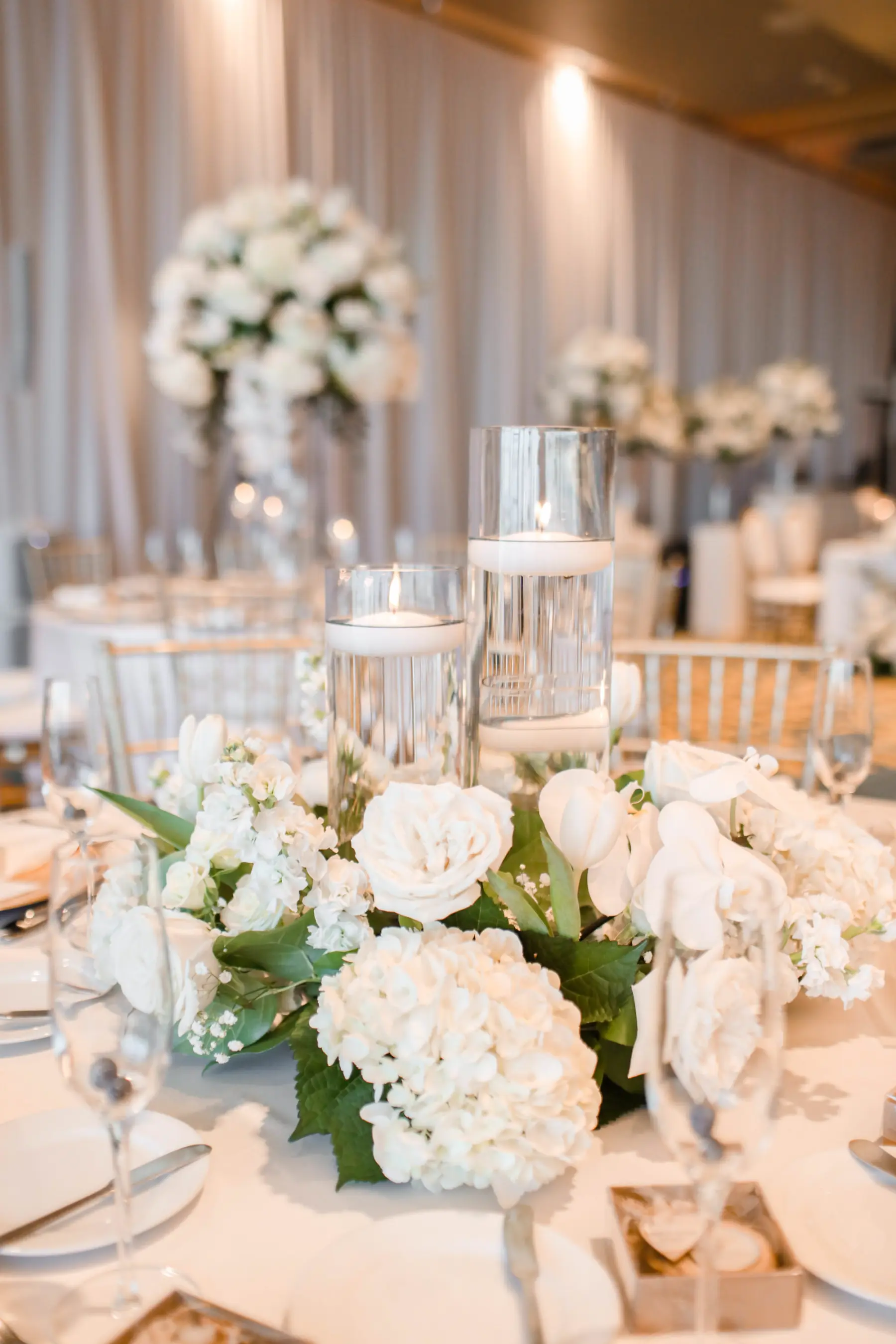 Elegant Monochromatic White Rose, Hydrangea, and Floating Candle Centerpiece Decor Inspiration