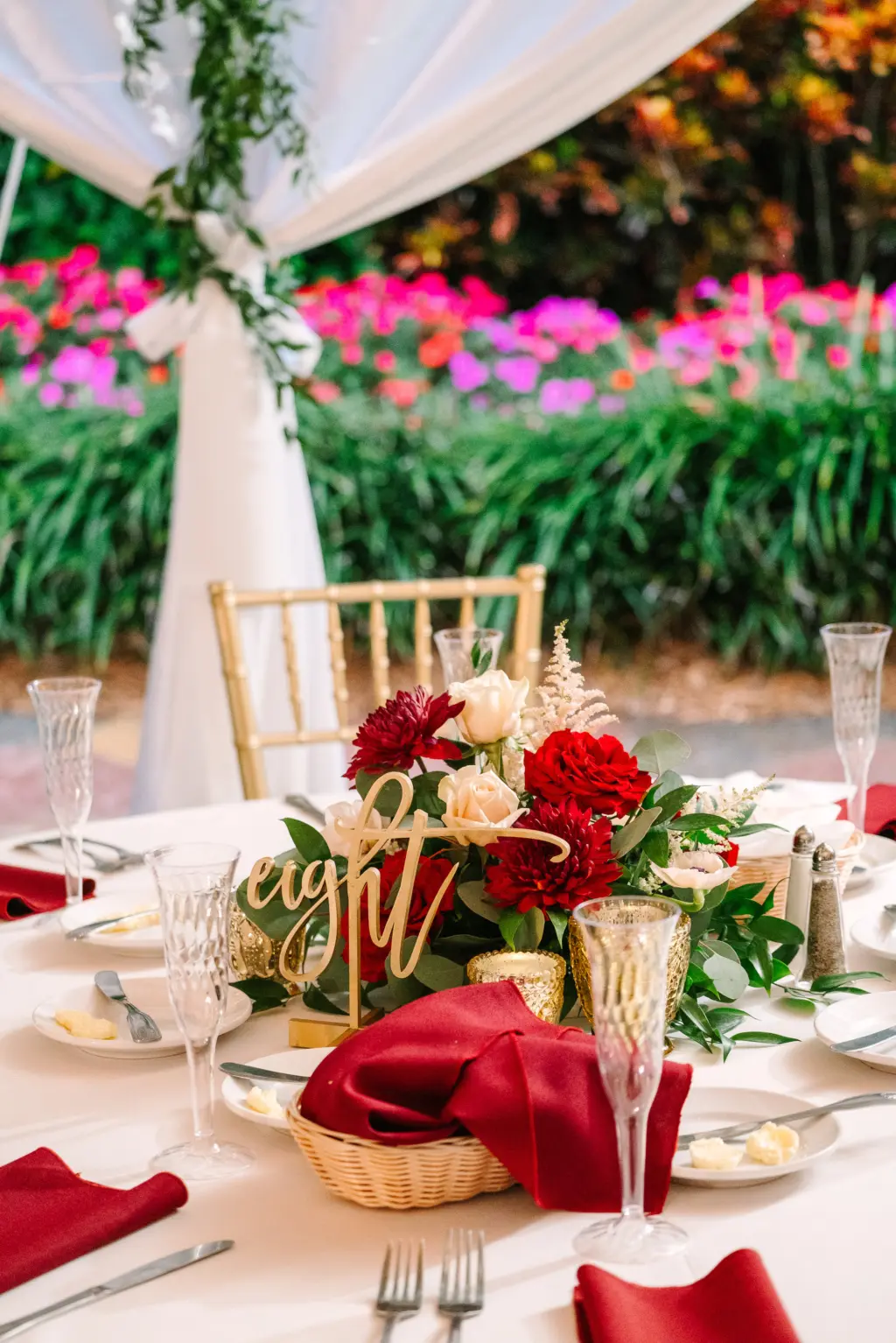 White and Red Christmas Inspired Wedding Reception Decor Ideas | Laser Cut Table Numbers | Red Roses, Chrysanthemums, White Anemone, and Greenery Centerpiece Inspiration | Gold Chiavari Chairs