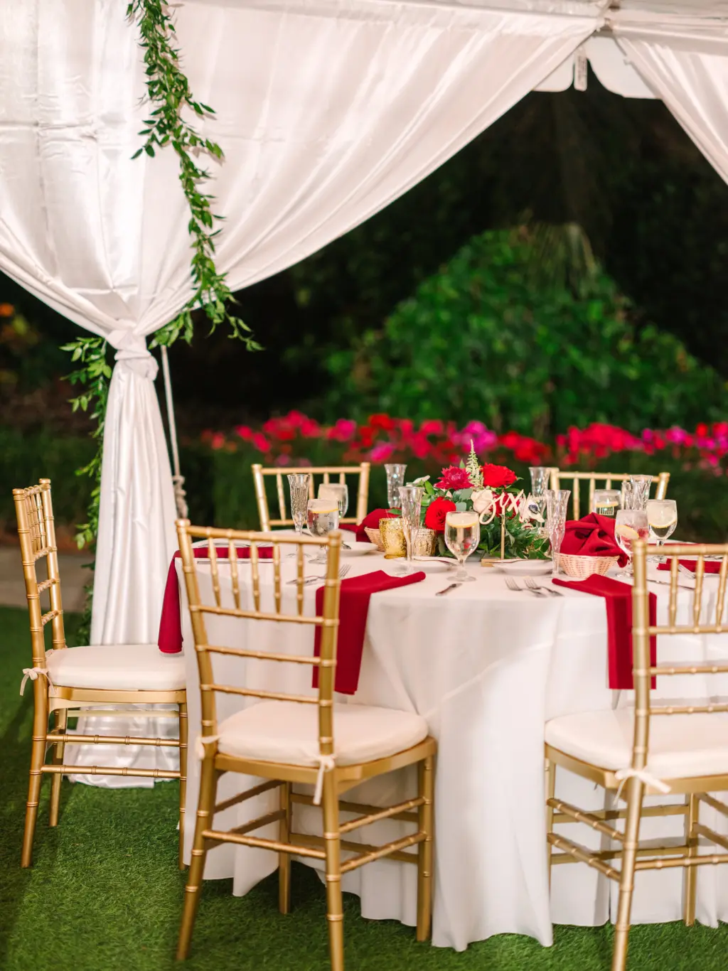 White and Red Christmas Inspired Wedding Reception Decor Ideas | Laser Cut Table Numbers | Red Rose, White Anemone, and Greenery Centerpiece Inspiration | Gold Chiavari Chairs | Tampa Bay Caterer Amici's Catering