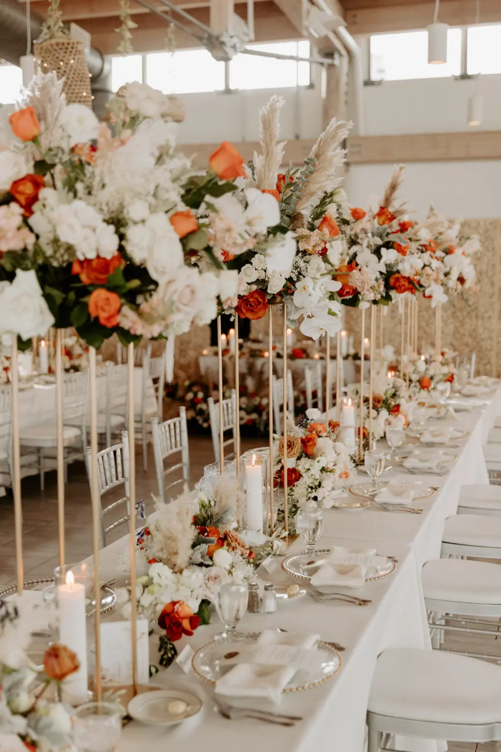 Tall Flower Stand Wedding Reception Centerpieces for Long Feasting Table with Pampas Grass, Orange, Pink, and White Roses, Carnations, Hydrangeas, and Dried Florals